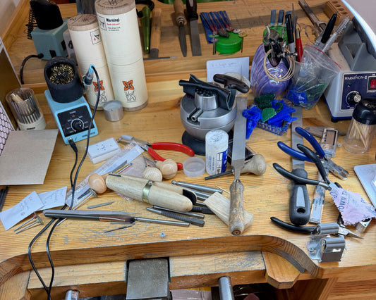 Madame Mak's jewellery bench in her wax carving jewellery making studio. Lots of tools, lots of work. 